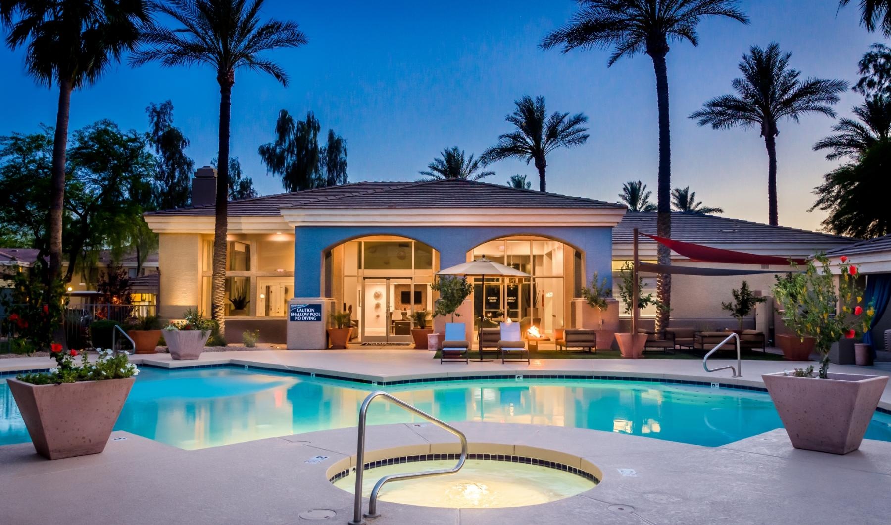 a swimming pool with a house in the background