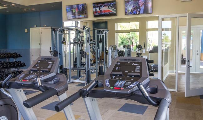 a gym with treadmills and treadmills